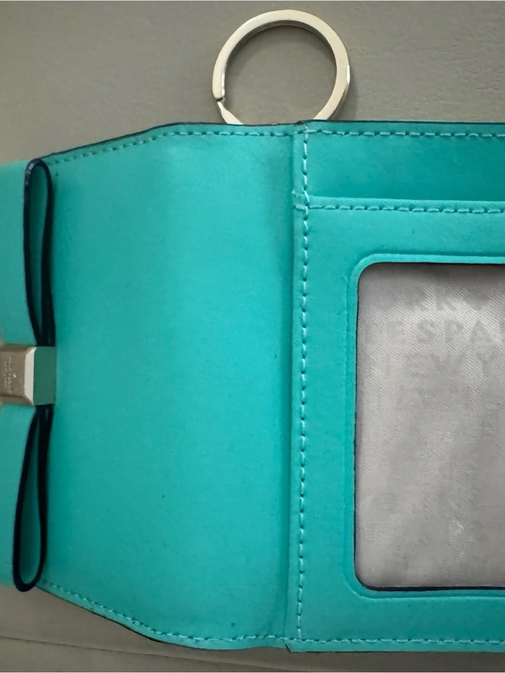 kate spade turquoise wristlet with gold logo